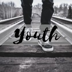 youth walking down a railroad